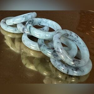 JADE ring featuring natural black flowers set on a base of light green color